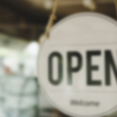 Open sign hangs in window at a shop.